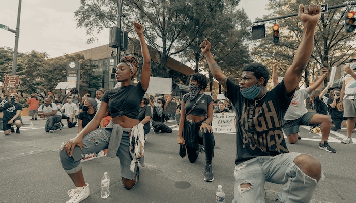 People Holding Up Fists During Protest
