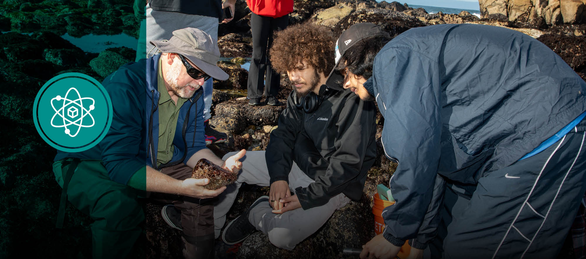 environmental science teacher showing students rock at ocean field trip