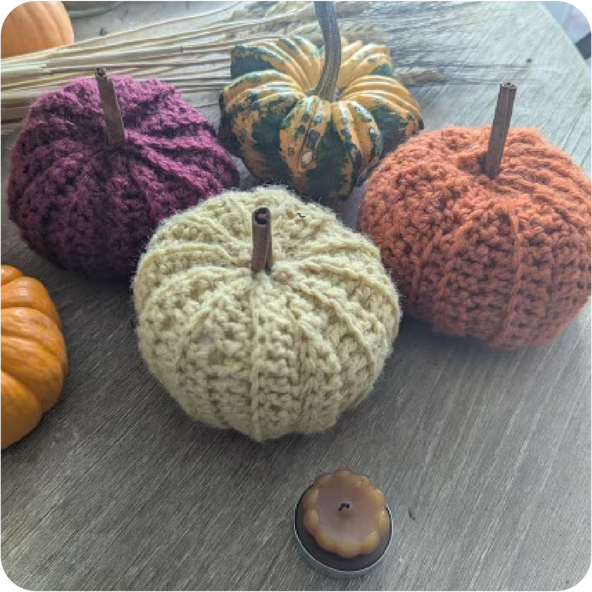 Crocheted Pumpins Next to Real Pumpkins