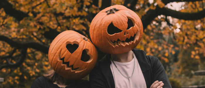 two people with jack-o-lanterns on their head