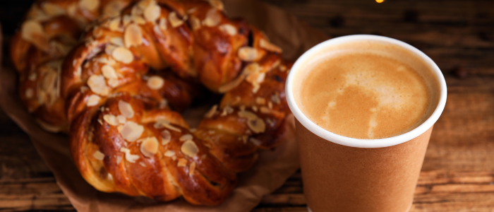 cup of coffee next to plate of pastries