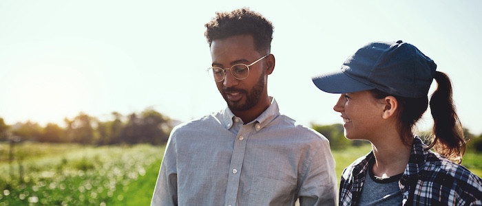 two people working in agriculture discussing outdoors