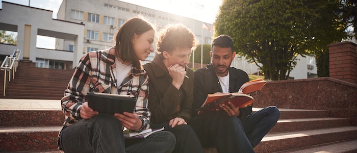 Three College Students Sitting Outside on Stairs