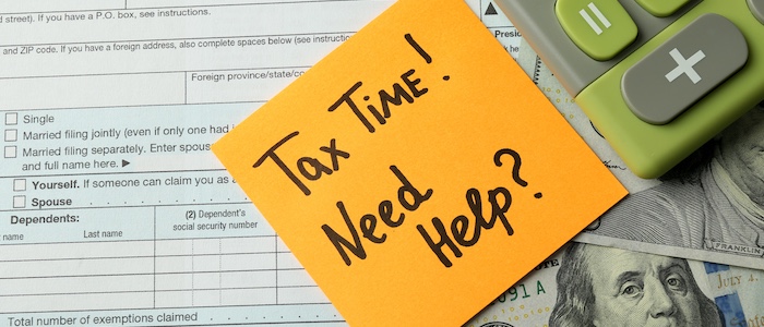 tax form with post it saying 'tax time! need help'