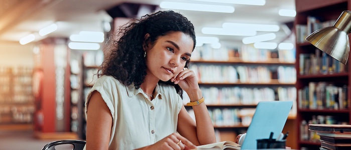 College Student Doing Work in the Library