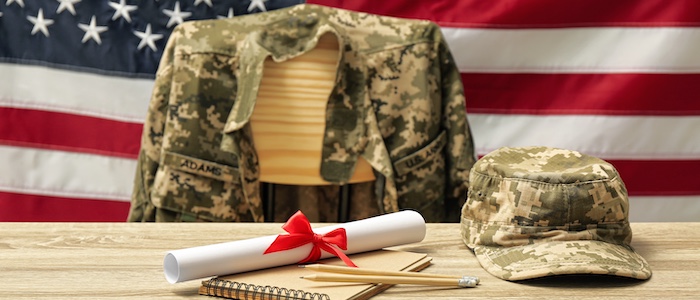 Diploma on Table in Front of Military Attire