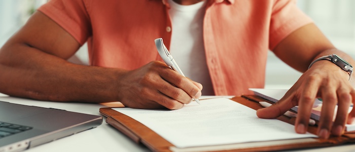 student writing notes in notebook