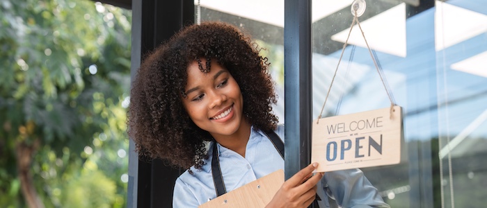 Black Entrepreneur Turning Open Sign on Business