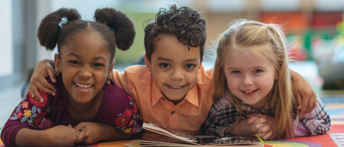 children laying down and smiling