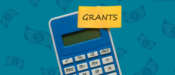 calculator with post it that says grants