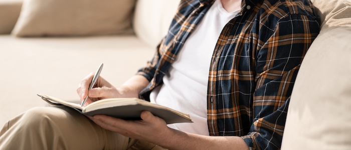 Man Writing in a Journal