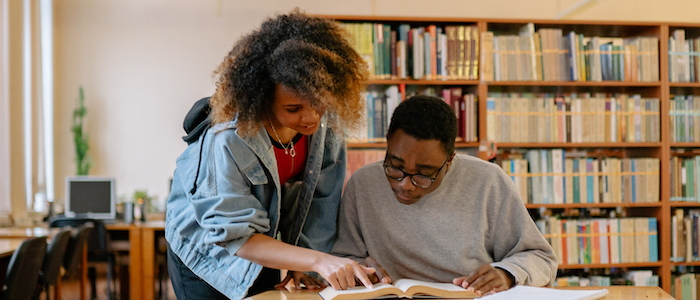 Students Working Together Reading a Book