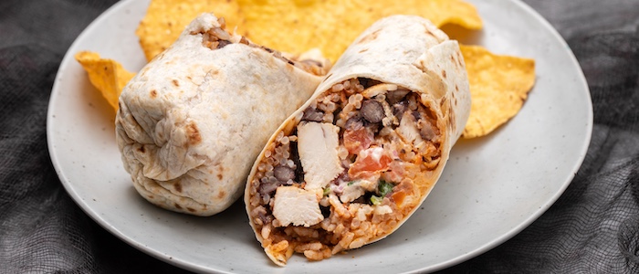 Burrito cut in half with tortilla chips