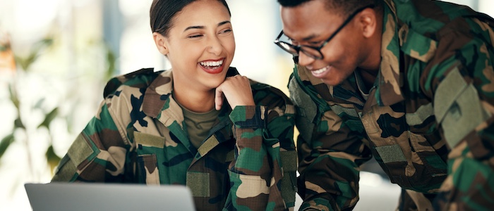Veterans doing work on laptop together
