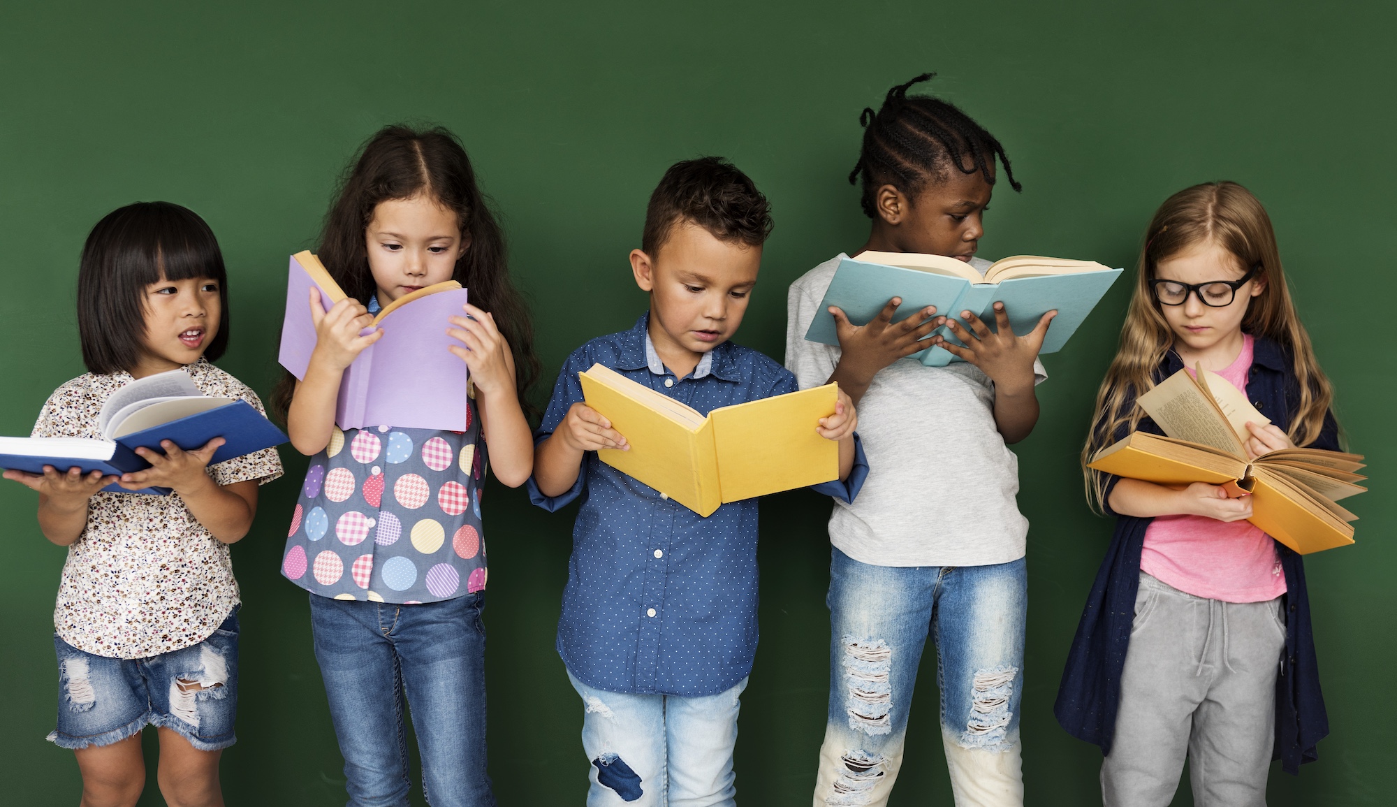 Three children reading a book together