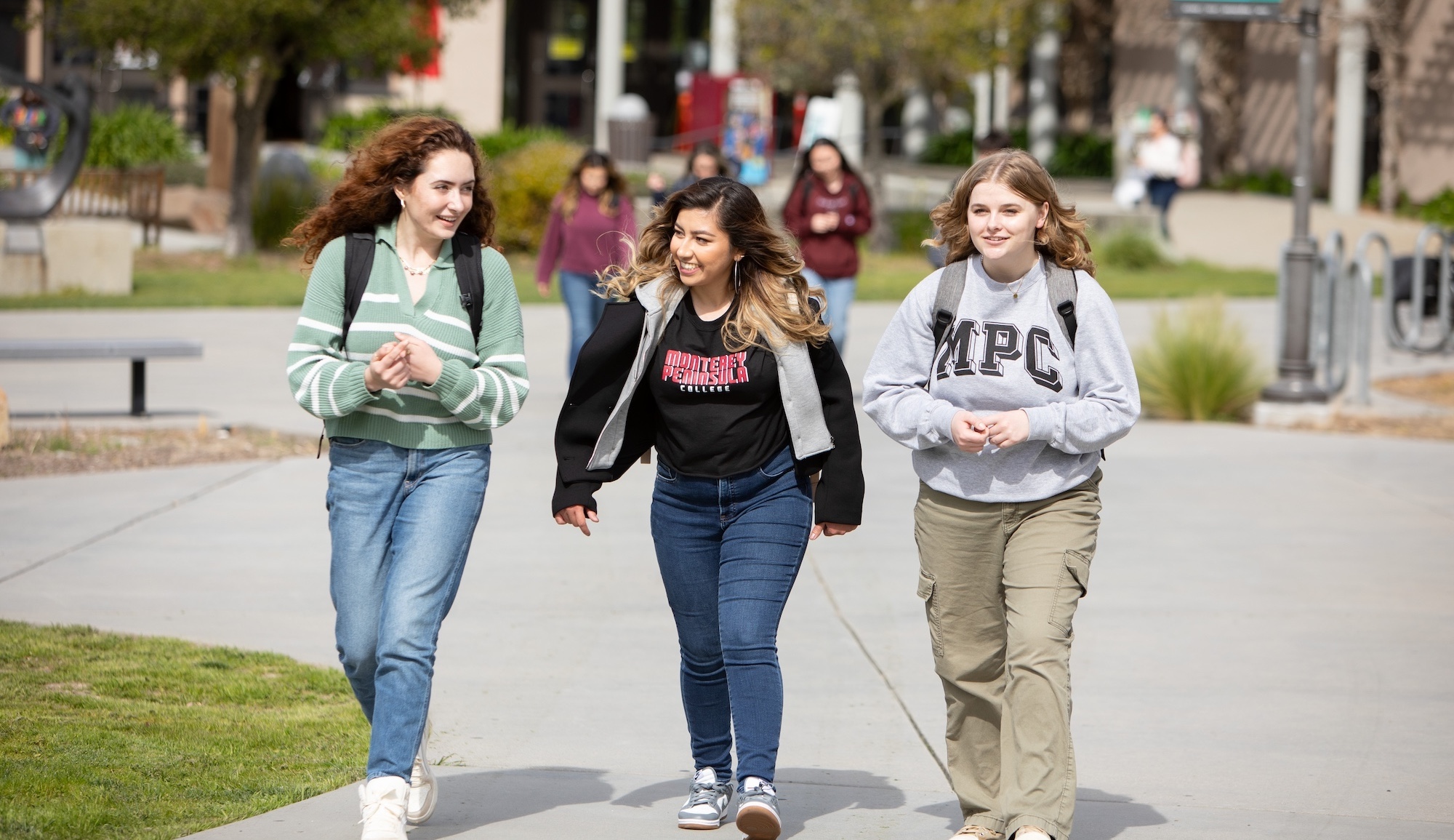 Four MPC Students on Campus Looking at Laptops