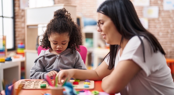 young child being taught by eced teacher