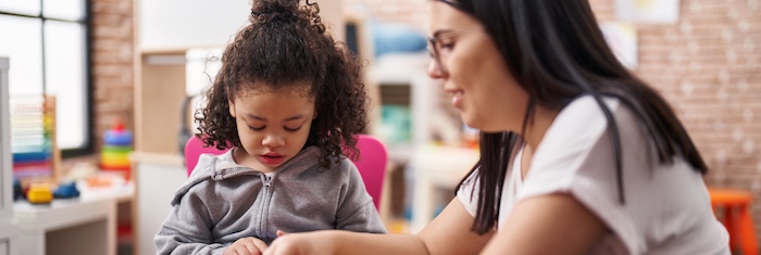 young child being taught by eced teacher