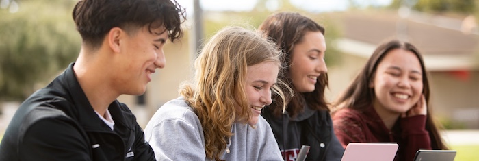 Four MPC Students on Campus on Laptops